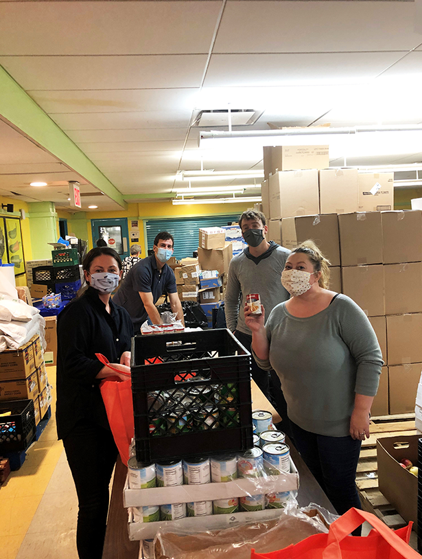 A group of colleagues gather canned food for charity.