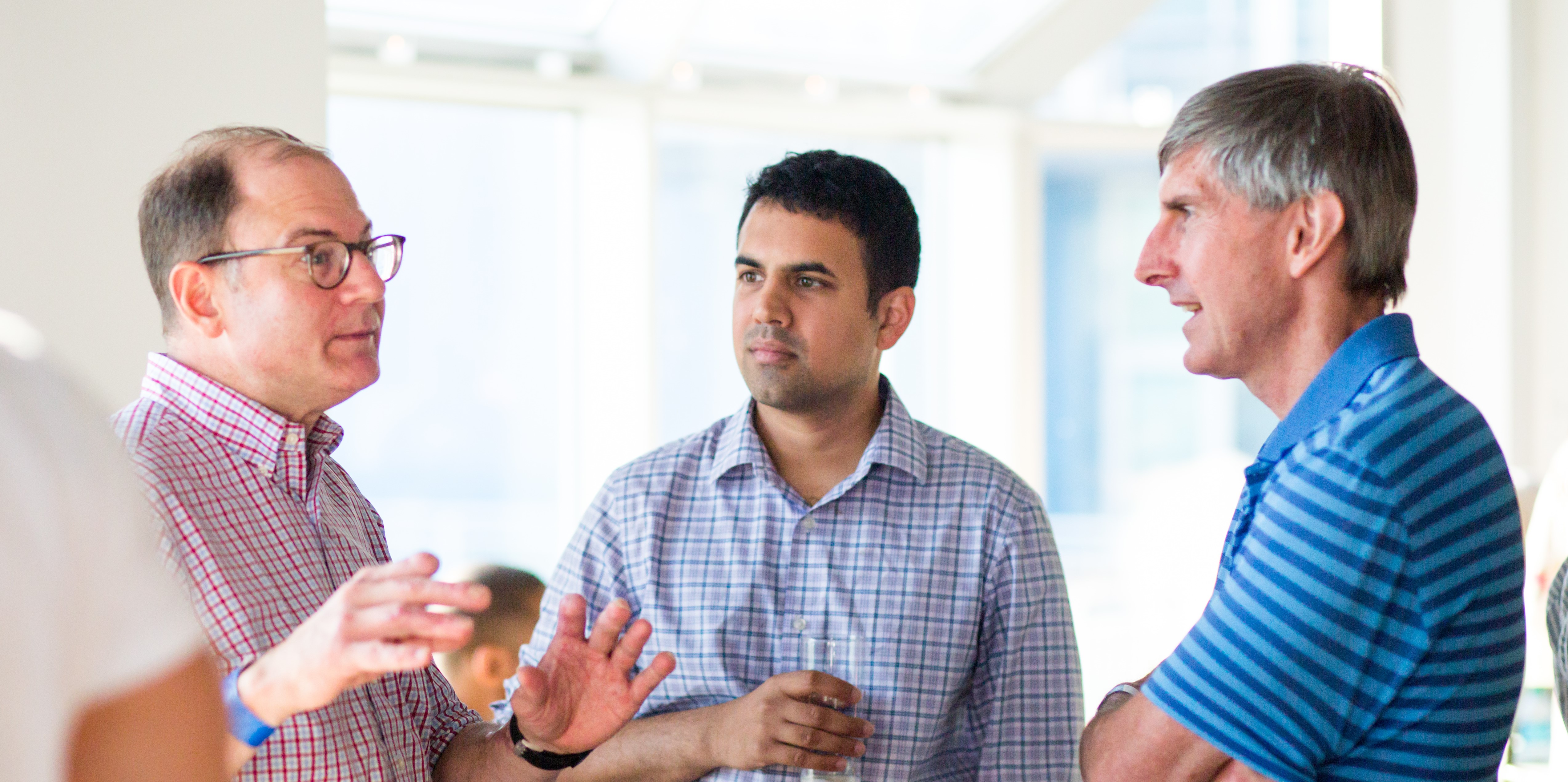 Three Viking employees in deep conversation with each other